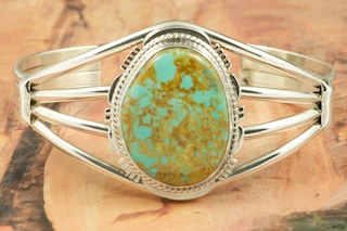 Genuine Manassa Turquoise set in Sterling Silver Bracelet. This Turquoise is also referred to as King�s Manassa Turquoise. The Manassa Turquoise mine is located in Manassa, Conejos County, Colorado. Created by Navajo Artist Margaret Platero. Signed.